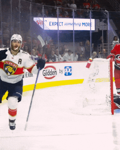 A Hockey Player Wearing A Florida Panthers Jersey Stands On The Ice In Front Of A Glidden By Ppg Sign GIF