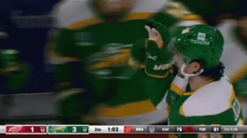 A Hockey Player Wearing A Green Helmet With Toyota On It GIF