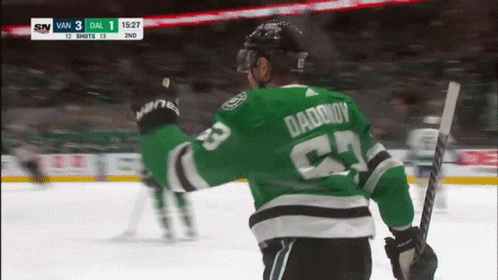 A Hockey Player Wearing A Green Jersey With Daddy On It GIF