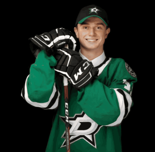 A Hockey Player Wearing A Green Jersey With The Letter D On The Front GIF
