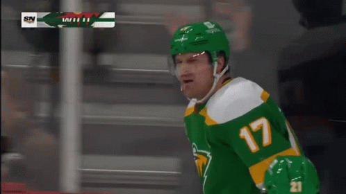 A Hockey Player Wearing A Green Jersey With The Number 17 GIF