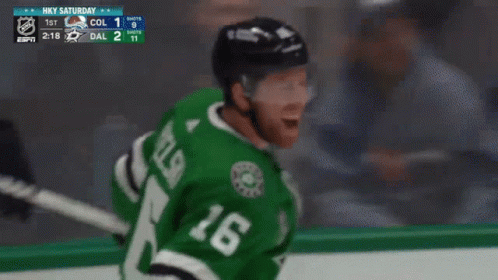 A Hockey Player Wearing A Green Jersey With The Number 18 On It GIF
