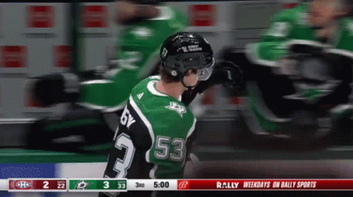 A Hockey Player Wearing A Green Jersey With The Number 53 On It GIF