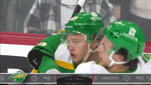 A Hockey Player Wearing A Green Toyota Helmet GIF