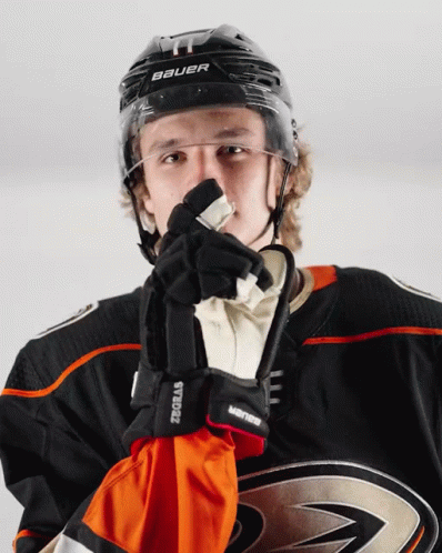 A Hockey Player Wearing A Helmet And Gloves With The Word Bauer On It GIF