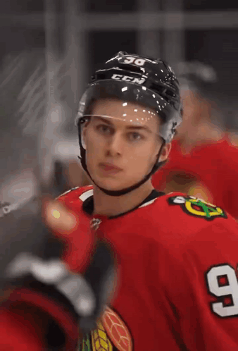 A Hockey Player Wearing A Helmet With The Letters Ccm On It GIF