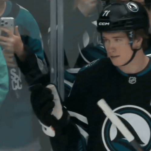 A Hockey Player Wearing A Helmet With The Number 11 On It GIF