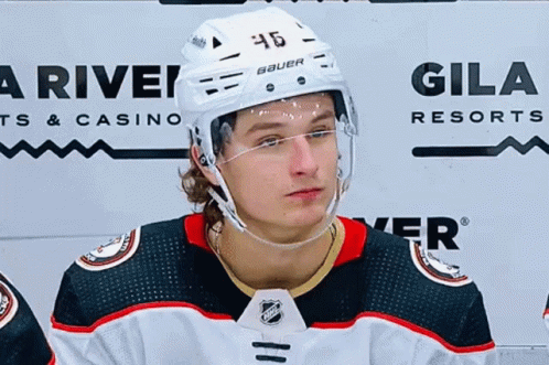 A Hockey Player Wearing A Helmet With The Number 46 On It . GIF