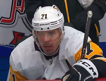 A Hockey Player Wearing A Helmet With The Number 71 GIF