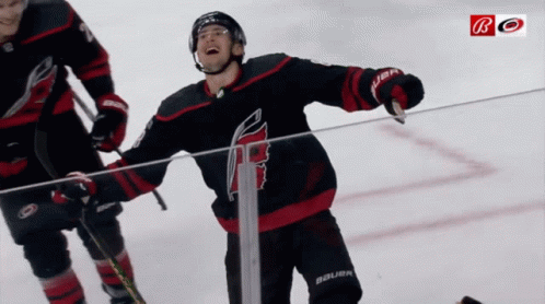 A Hockey Player Wearing A Jersey That Says Bauer Is Standing On The Ice GIF