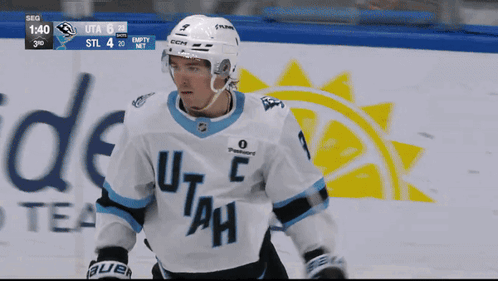 A Hockey Player Wearing A Jersey That Says Utah GIF