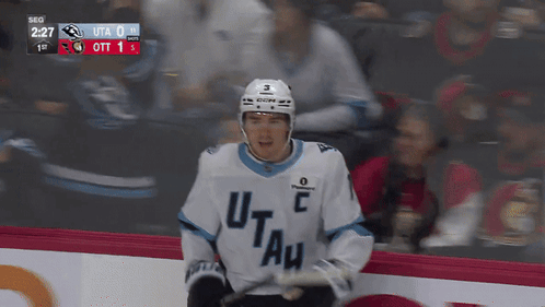 A Hockey Player Wearing A Jersey That Says Utah GIF