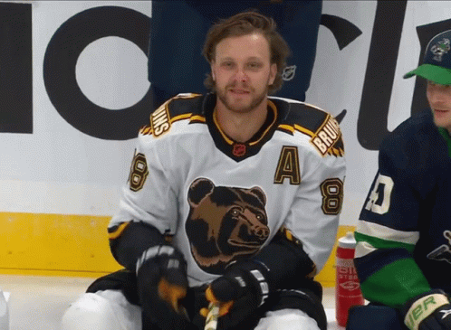 A Hockey Player Wearing A Jersey With A Bear On It GIF