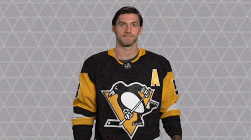 A Hockey Player Wearing A Jersey With A Penguin On It GIF