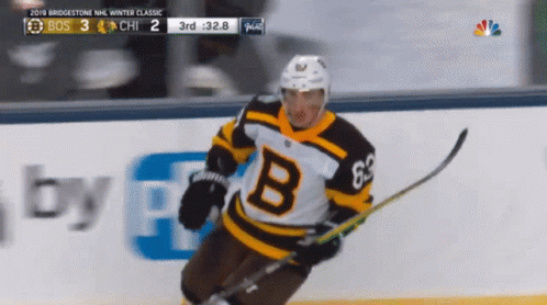 A Hockey Player Wearing A Jersey With The Letter B On The Front GIF