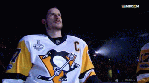 A Hockey Player Wearing A Jersey With The Letter C On The Front GIF