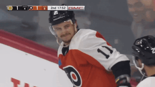 A Hockey Player Wearing A Jersey With The Number 11 GIF