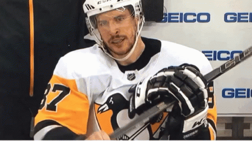 A Hockey Player Wearing A Jersey With The Number 37 On It GIF