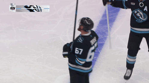 A Hockey Player Wearing A Jersey With The Number 67 GIF