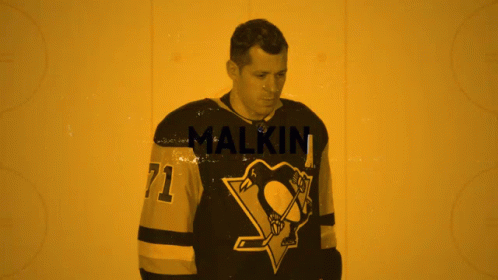 A Hockey Player Wearing A Jersey With The Number 71 GIF