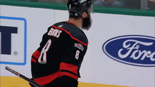 A Hockey Player Wearing A Jersey With The Number 8 On It GIF