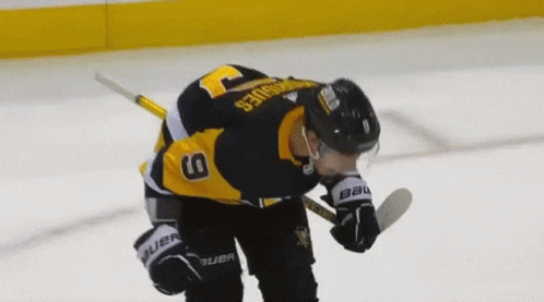 A Hockey Player Wearing A Jersey With The Number 9 On It GIF