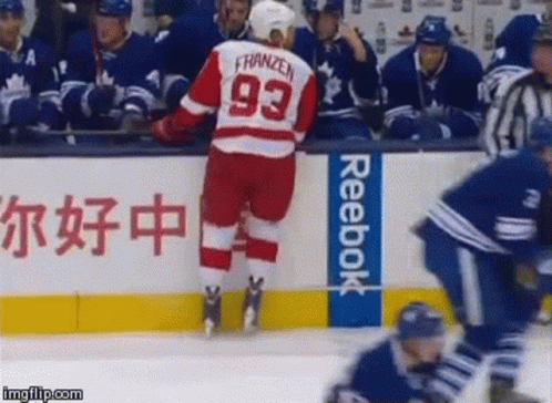 A Hockey Player Wearing A Jersey With The Number 93 On It GIF