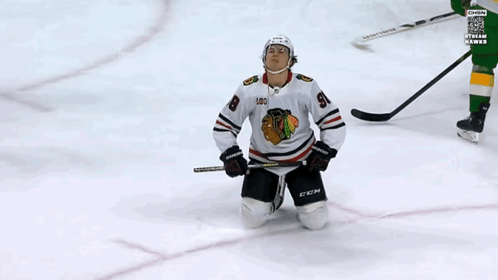 A Hockey Player Wearing A Jersey With The Number 98 On It GIF