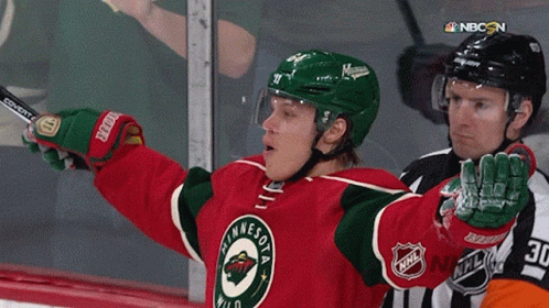 A Hockey Player Wearing A Minnesota Wild Jersey Holds Up His Arms GIF