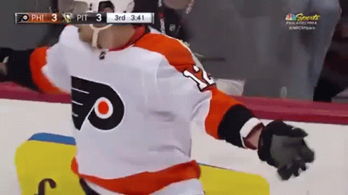 A Hockey Player Wearing A Number 11 Jersey Is Standing On The Ice GIF