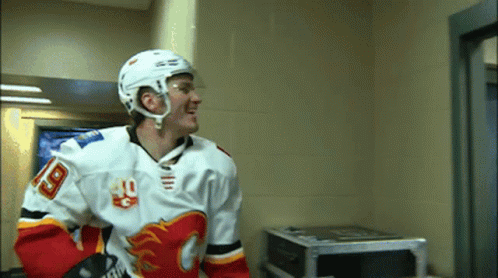 A Hockey Player Wearing A Number 18 Jersey GIF