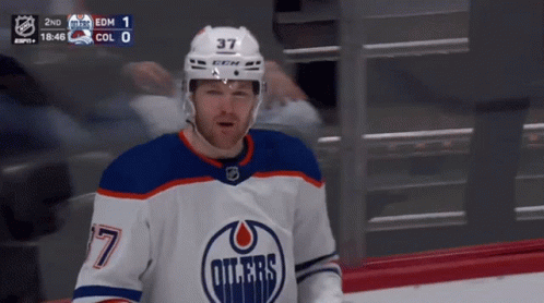 A Hockey Player Wearing A Number 37 Jersey GIF