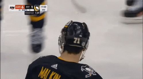A Hockey Player Wearing A Number 71 Jersey GIF