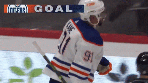 A Hockey Player Wearing A Number 9 Jersey Stands On The Ice GIF