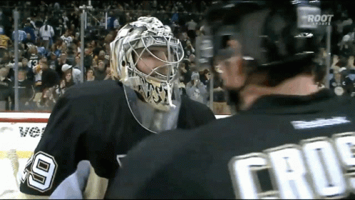 A Hockey Player Wearing A Number 9 Jersey Talks To Another Player GIF