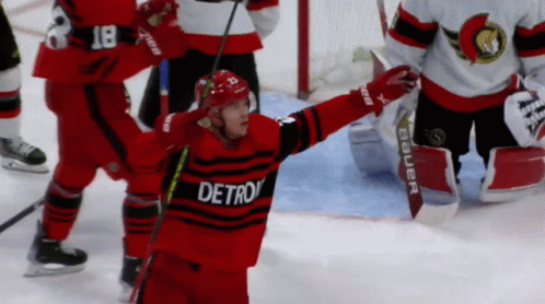A Hockey Player Wearing A Red And Black Detroit Jersey GIF