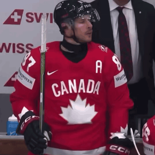 A Hockey Player Wearing A Red Jersey With Canada On It GIF