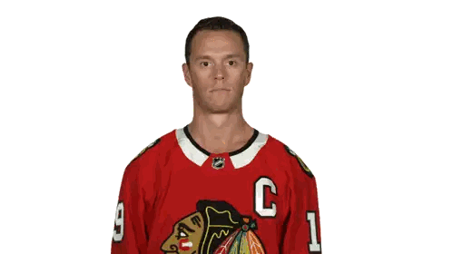 a hockey player wearing a red jersey with the letter c on it