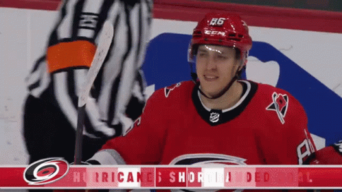 A Hockey Player Wearing A Red Jersey With The Number 26 On It GIF