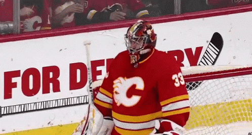 A Hockey Player Wearing A Red Jersey With The Number 33 GIF