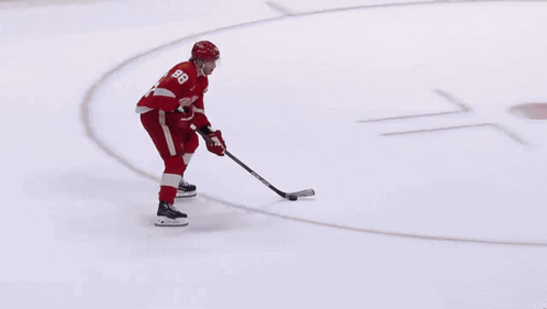 A Hockey Player Wearing A Red Jersey With The Number 8 On It GIF