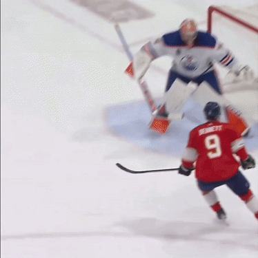 A Hockey Player Wearing A Red Jersey With The Number 9 On It GIF