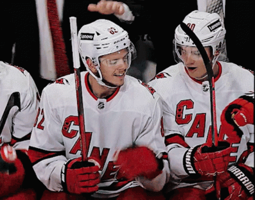 A Hockey Player Wearing A White Jersey With The Letter G On It GIF
