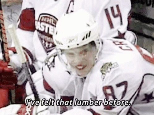 A Hockey Player Wearing A White Jersey With The Number 14 On It GIF
