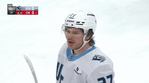 A Hockey Player Wearing A White Jersey With The Number 27 GIF