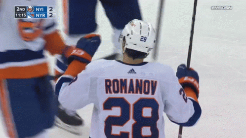 A Hockey Player Wearing A White Jersey With The Number 28 On It GIF