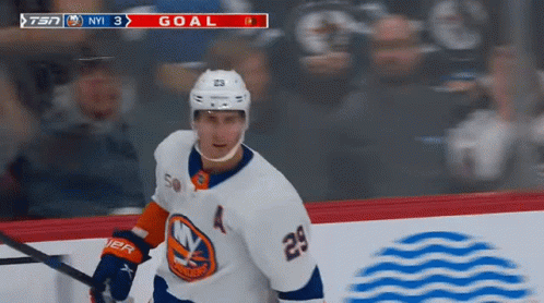 A Hockey Player Wearing A White Jersey With The Number 29 On It GIF