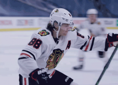 A Hockey Player Wearing A White Jersey With The Number 88 On It GIF