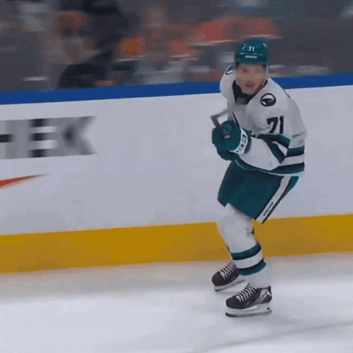 A Hockey Player Wearing Number 71 Is Holding A Hockey Stick GIF