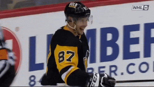A Hockey Player Wearing The Number 87 Jersey GIF